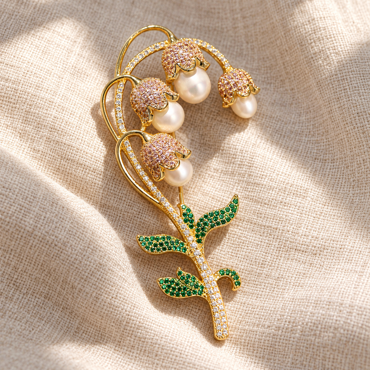 Lily of the valley brooch with gold-tone freshwater pearl drops, tabletop view