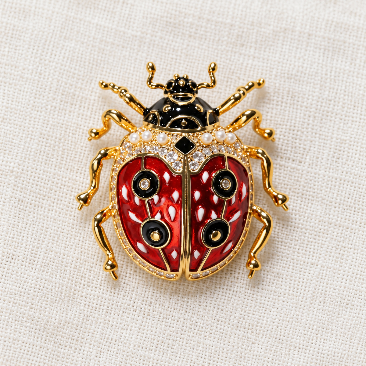 Gold Tone ladybug brooch in a tabletop setting