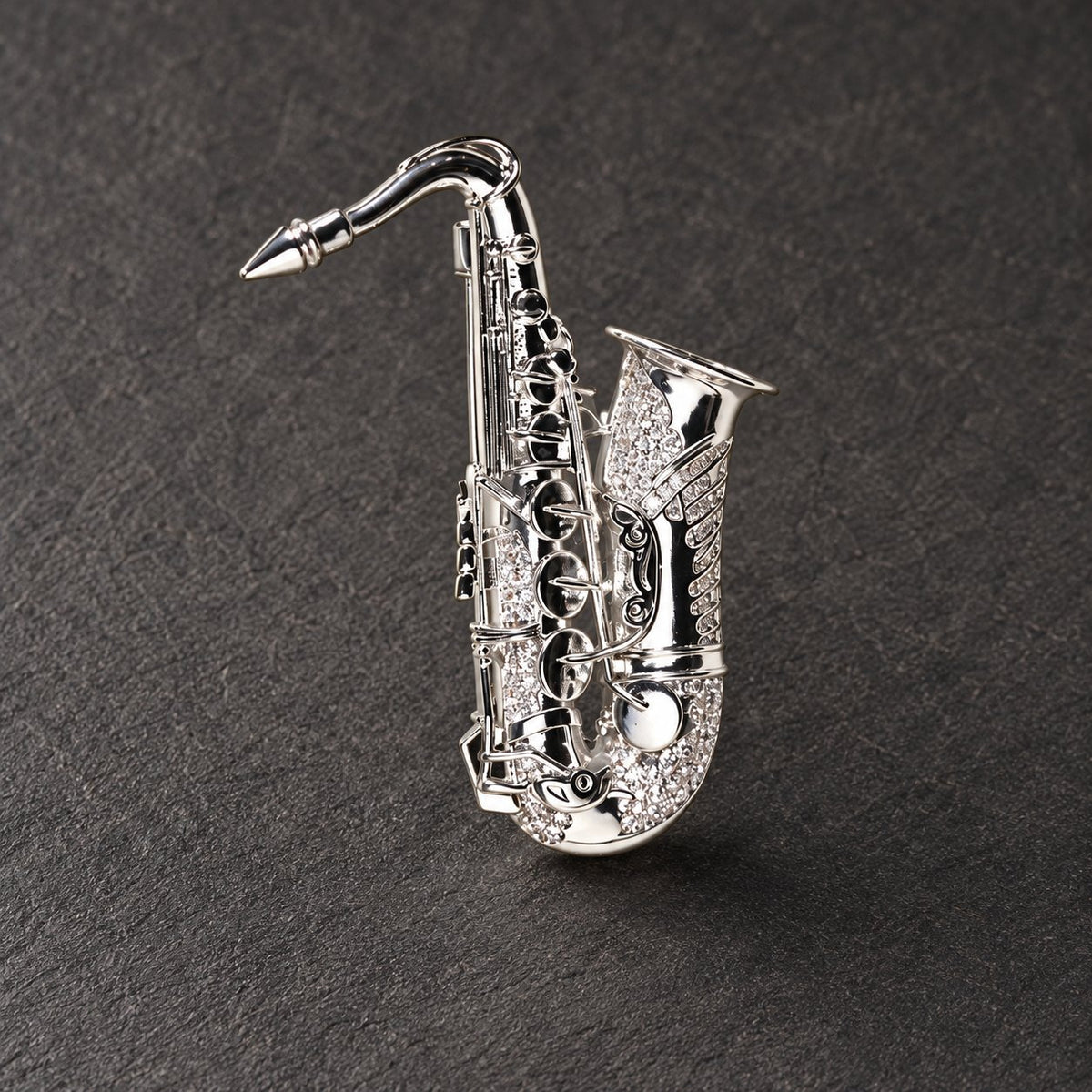 Silver tone saxophone brooch, full front view
