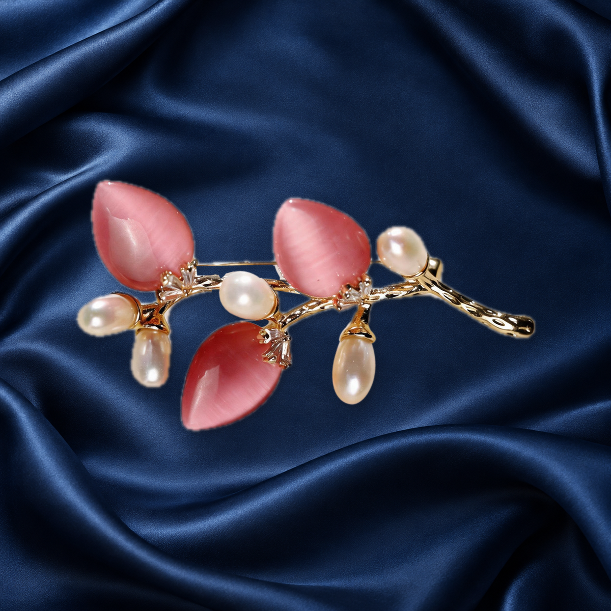 Pink cat-eye stone flower branch brooch with freshwater pearls on navy satin