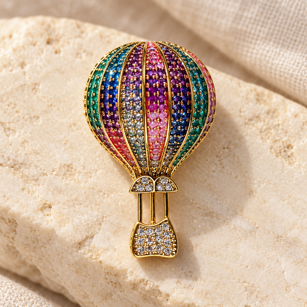 Gold Multicolor hot air balloon brooch and pendant in a styled tabletop display