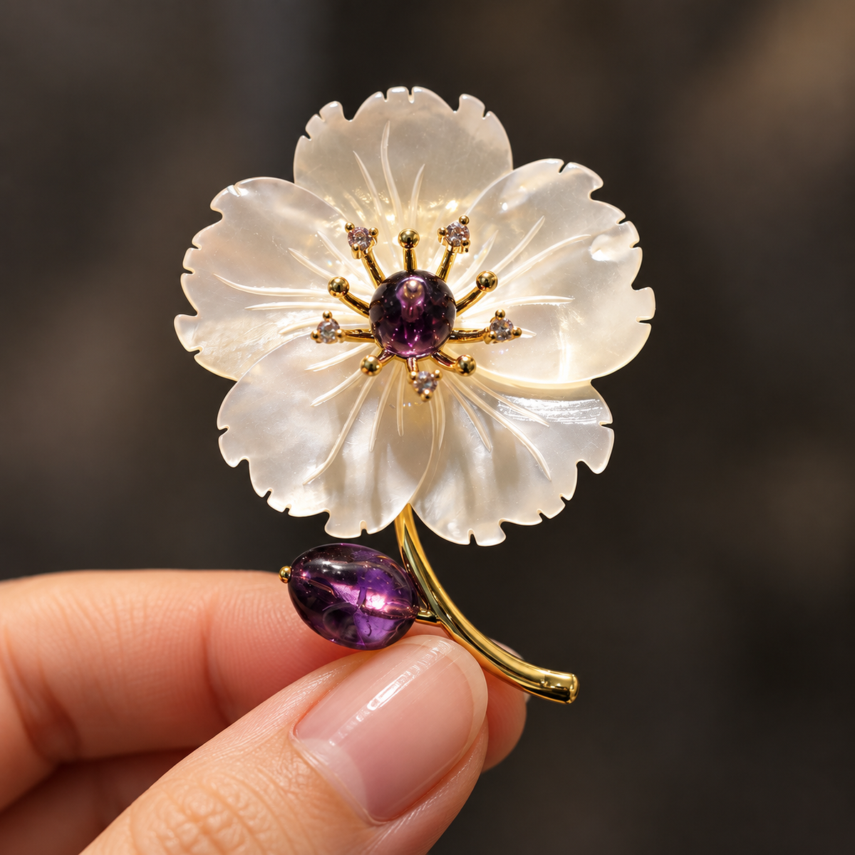Purple shell flower brooch held in a hand