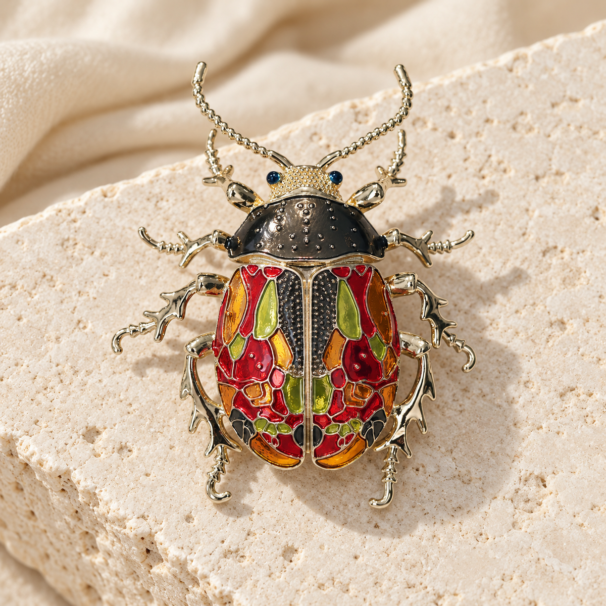 Multicolor enamel beetle brooch, styled tabletop display
