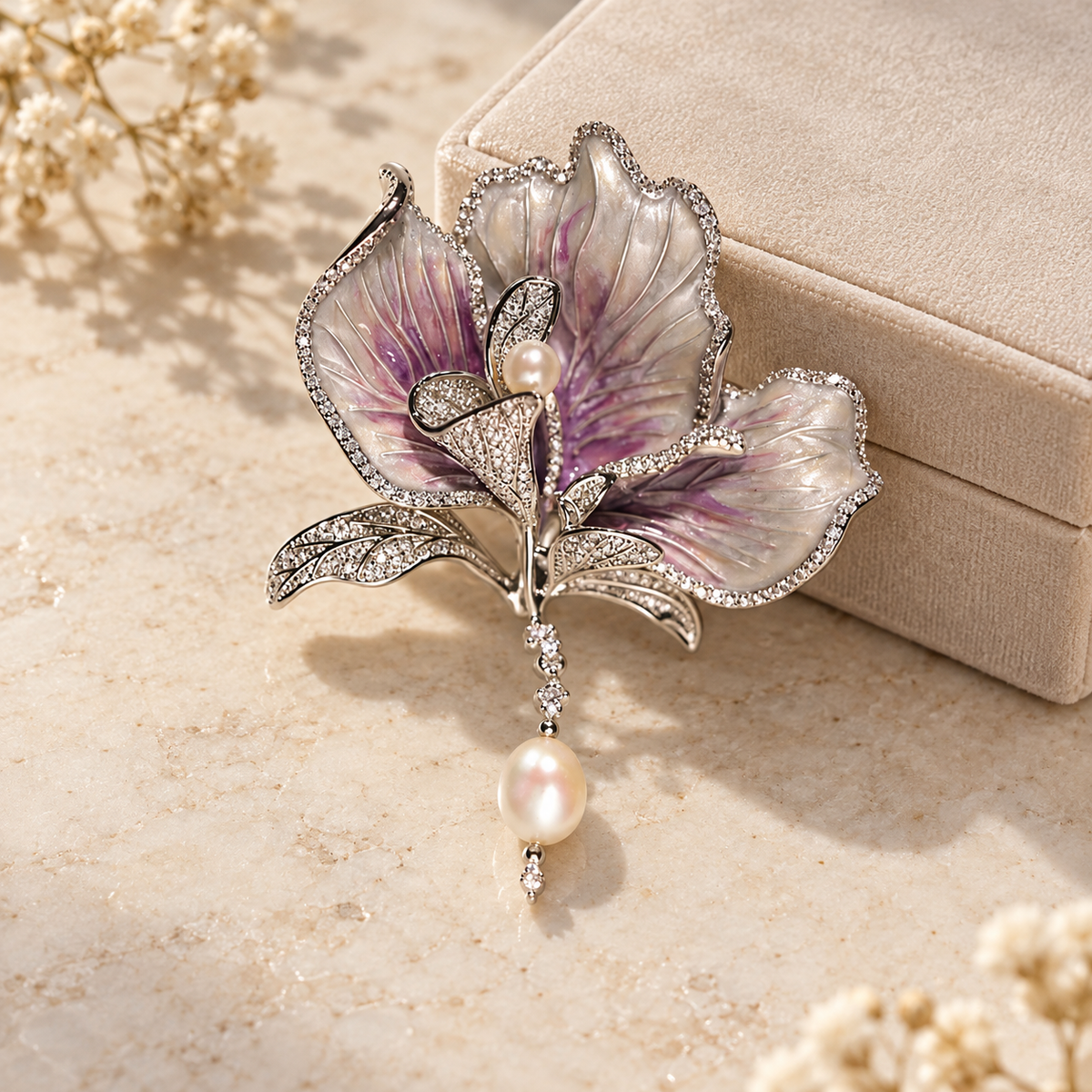 Purple with Freshwater Pearl canna flower brooch in a tabletop display