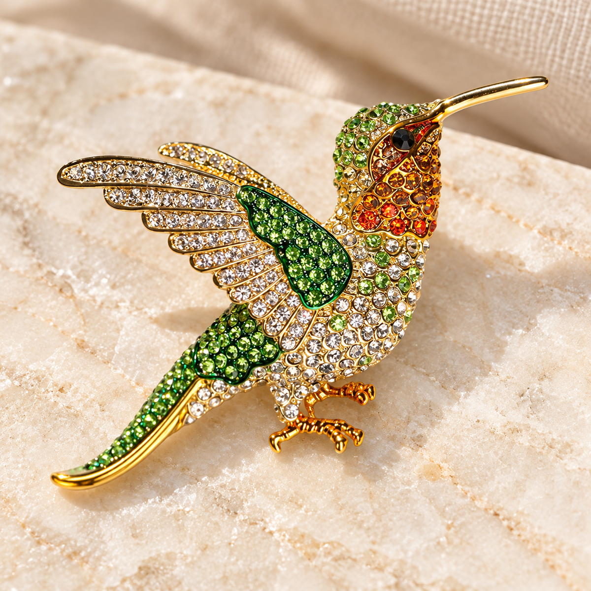 Green hummingbird brooch in a styled tabletop display