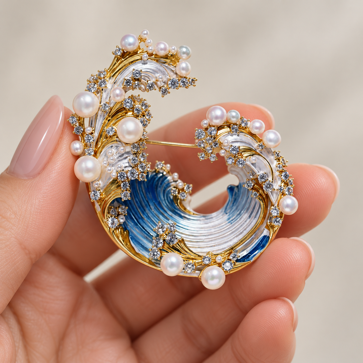 Freshwater pearl wave brooch and pendant held in a hand