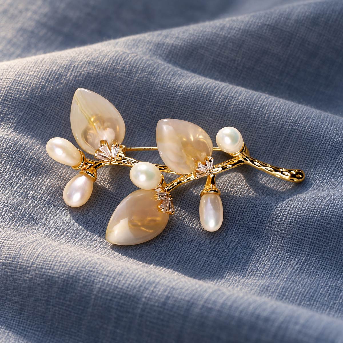 Gold White natural stone flower branch brooch with freshwater pearls in a styled scene