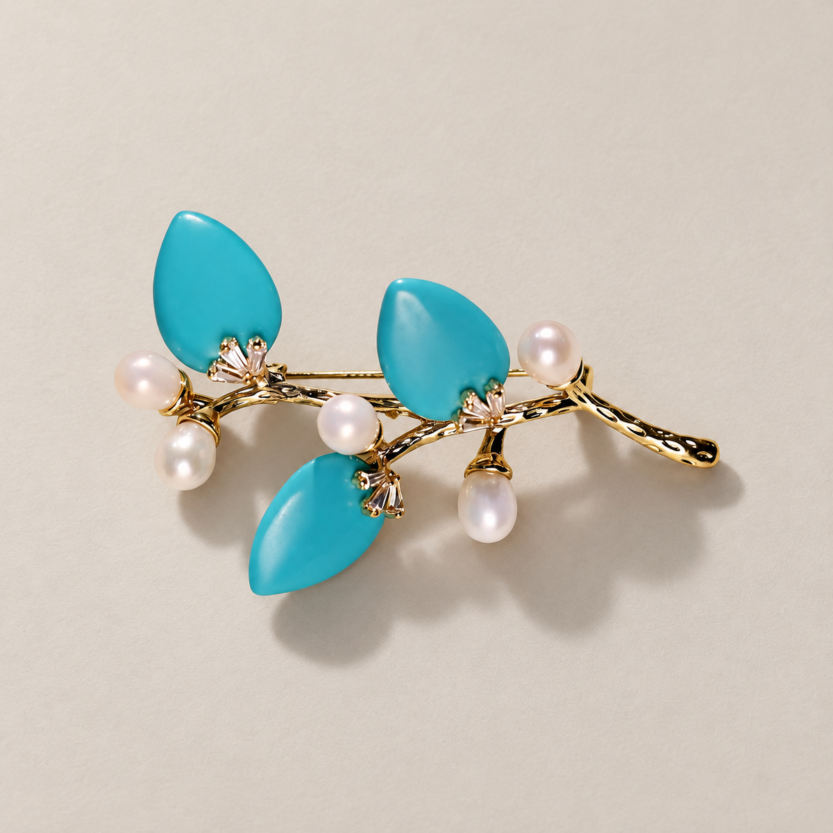 Blue natural stone flower branch brooch with freshwater pearls on a neutral background