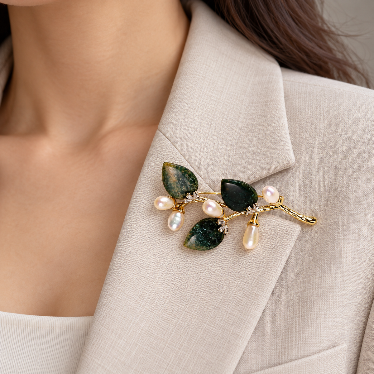Dark Green natural stone flower branch brooch with freshwater pearls worn on a blazer lapel