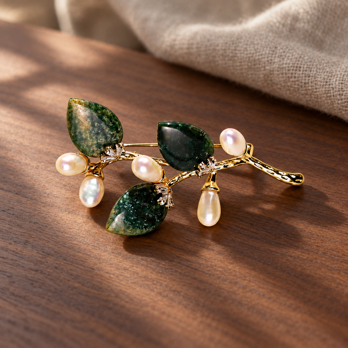 Dark Green natural stone flower branch brooch with freshwater pearls in a styled scene