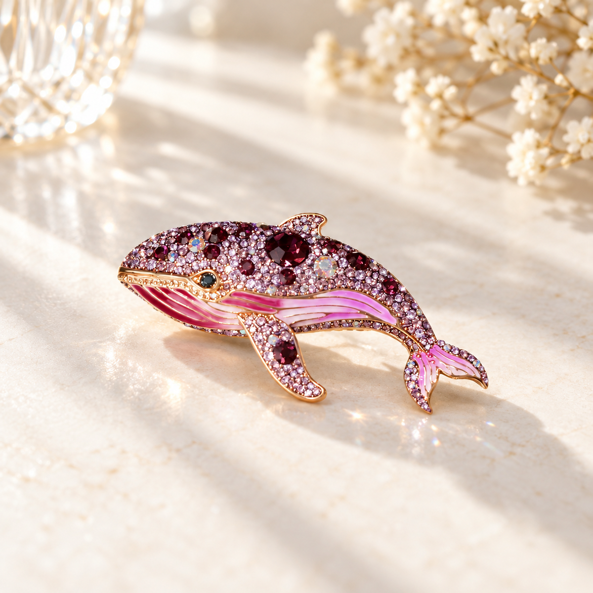 Purple whale brooch on a light tabletop