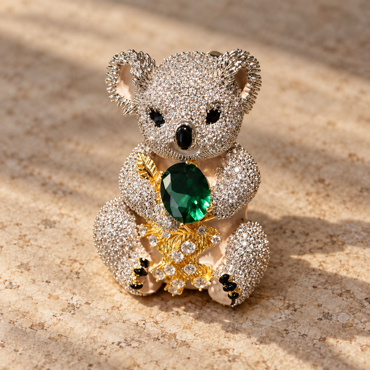 Emerald Green Koala brooch in a tabletop setting