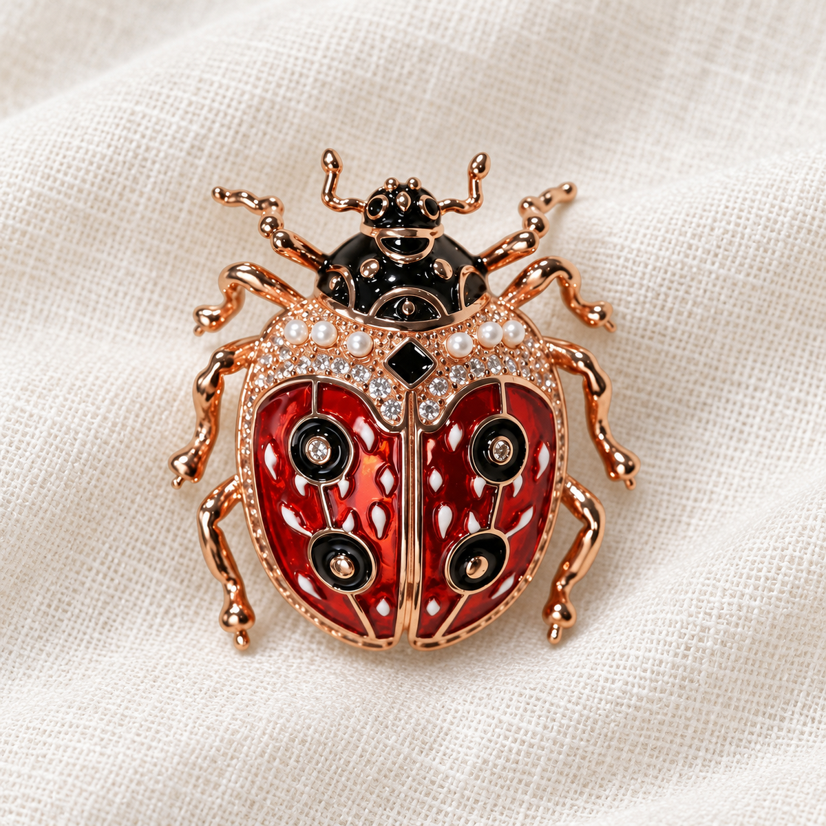 Rose Gold Tone ladybug brooch in a tabletop setting