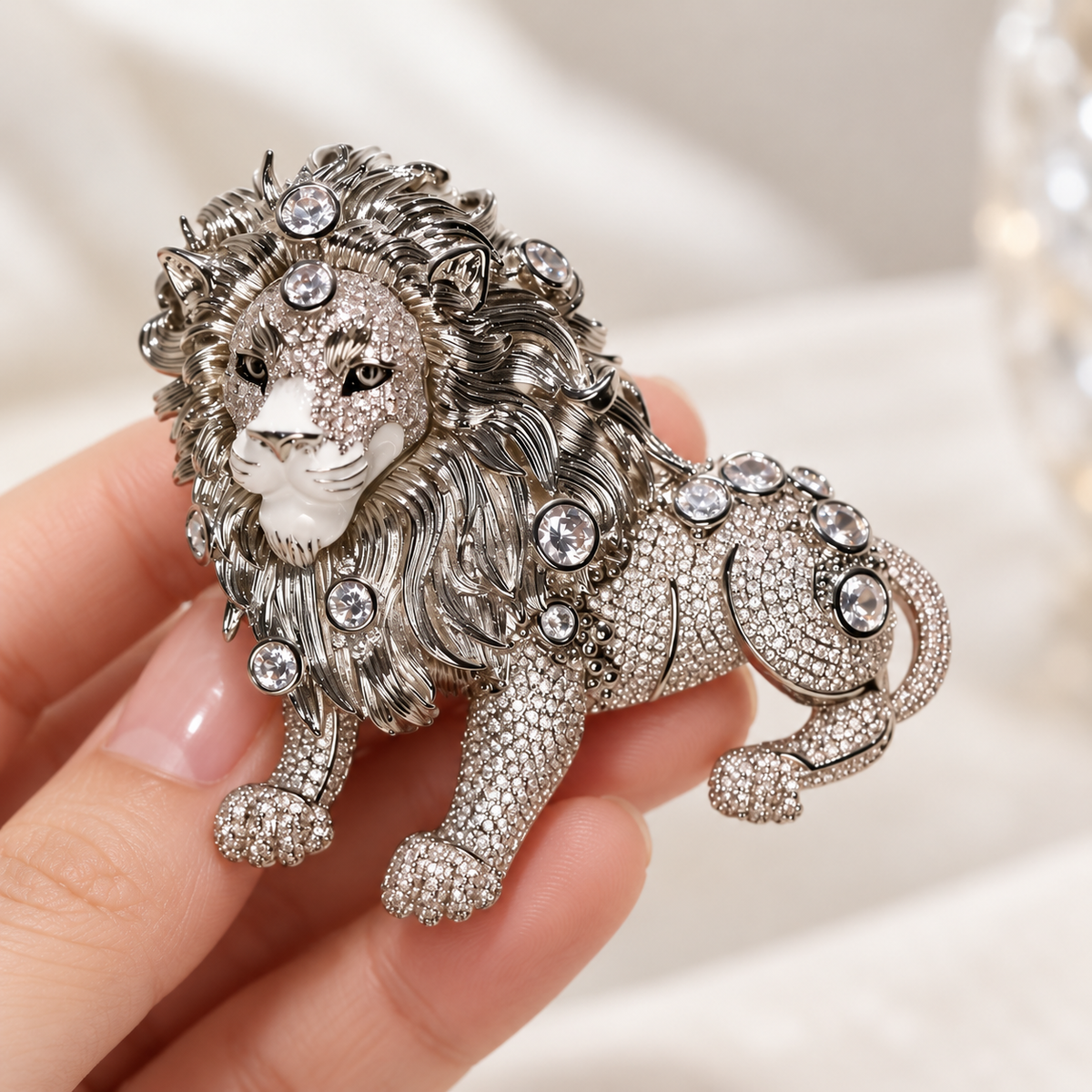 Silver Tone Lion brooch held in a hand