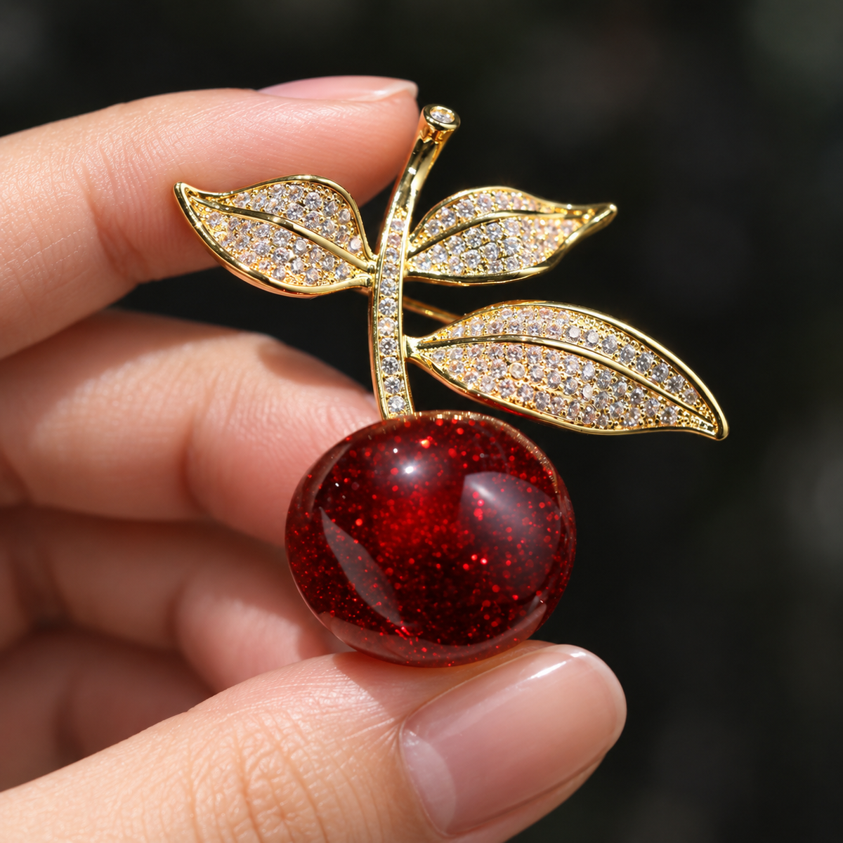 Vintage Cherry brooch held in a hand