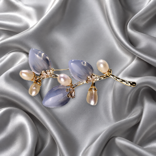 Blue cat-eye stone flower branch brooch with freshwater pearls on silver-grey satin