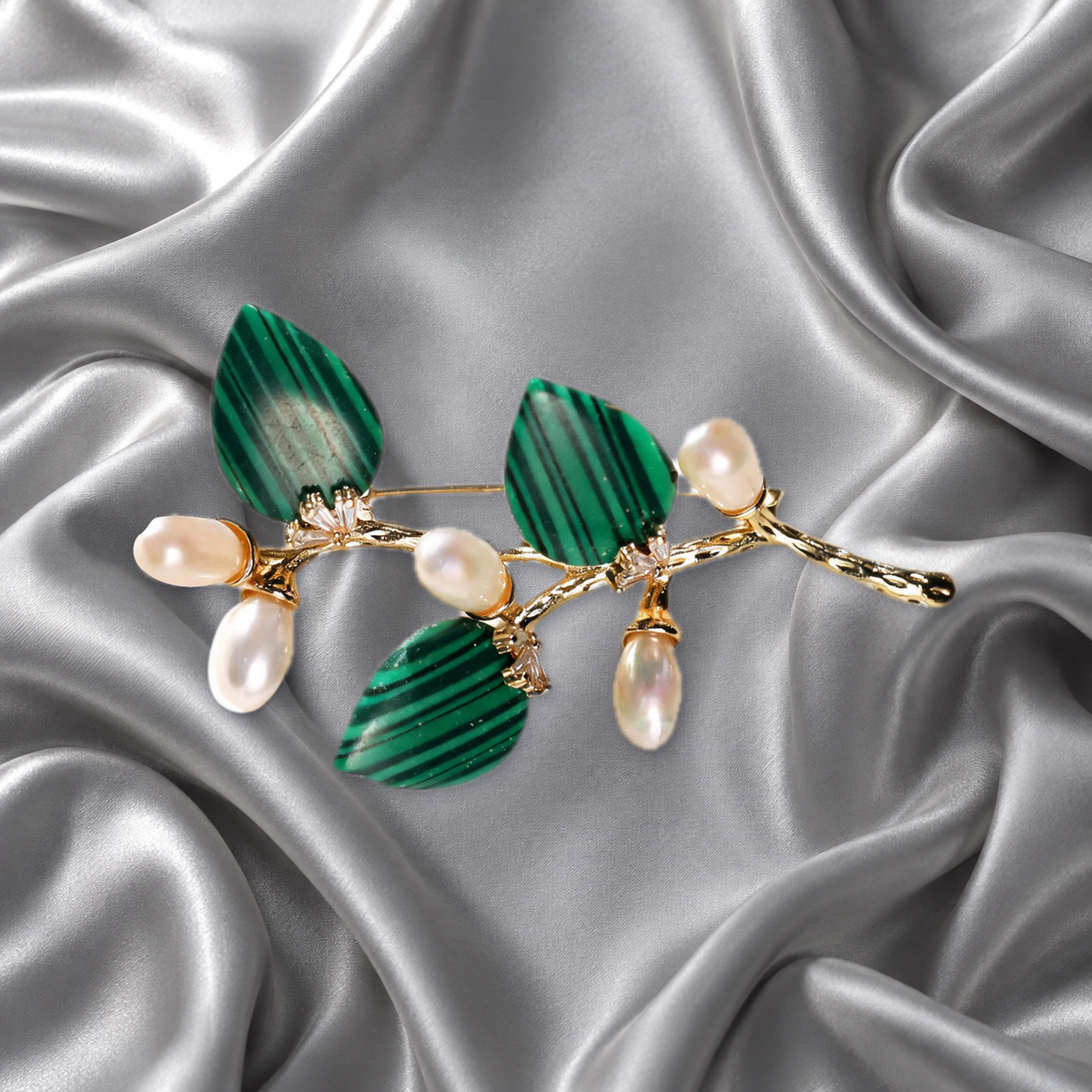 Green natural stone flower branch brooch with freshwater pearls on silver-grey satin