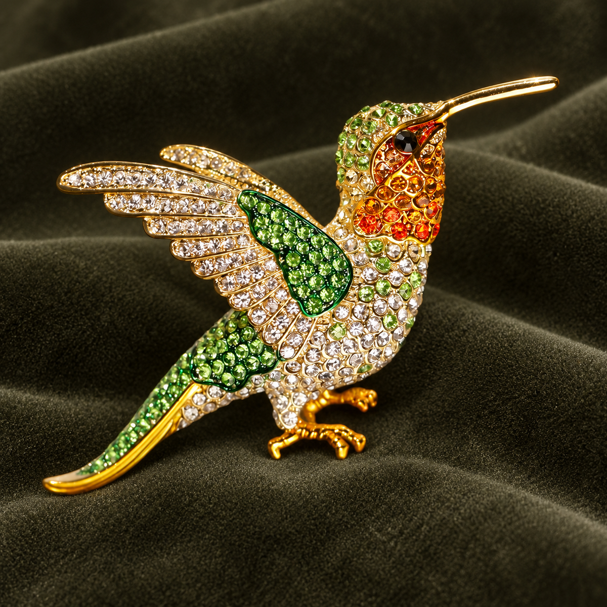 Green hummingbird brooch with bright green wing detail, an orange throat and a curved tail