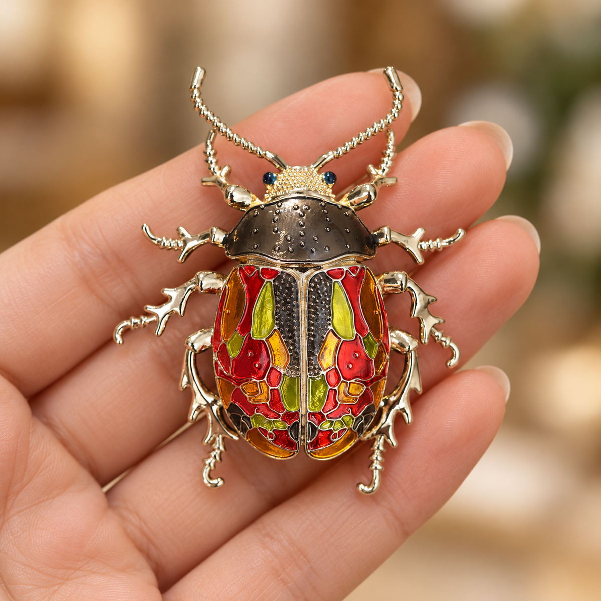 Multicolor enamel beetle brooch, held in a hand