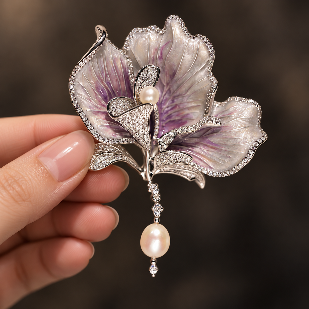 Purple with Freshwater Pearl canna flower brooch held in a hand