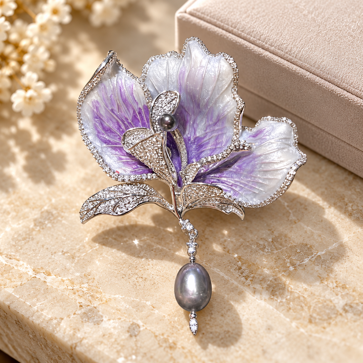 Purple with Gray Pearl canna flower brooch in a tabletop display