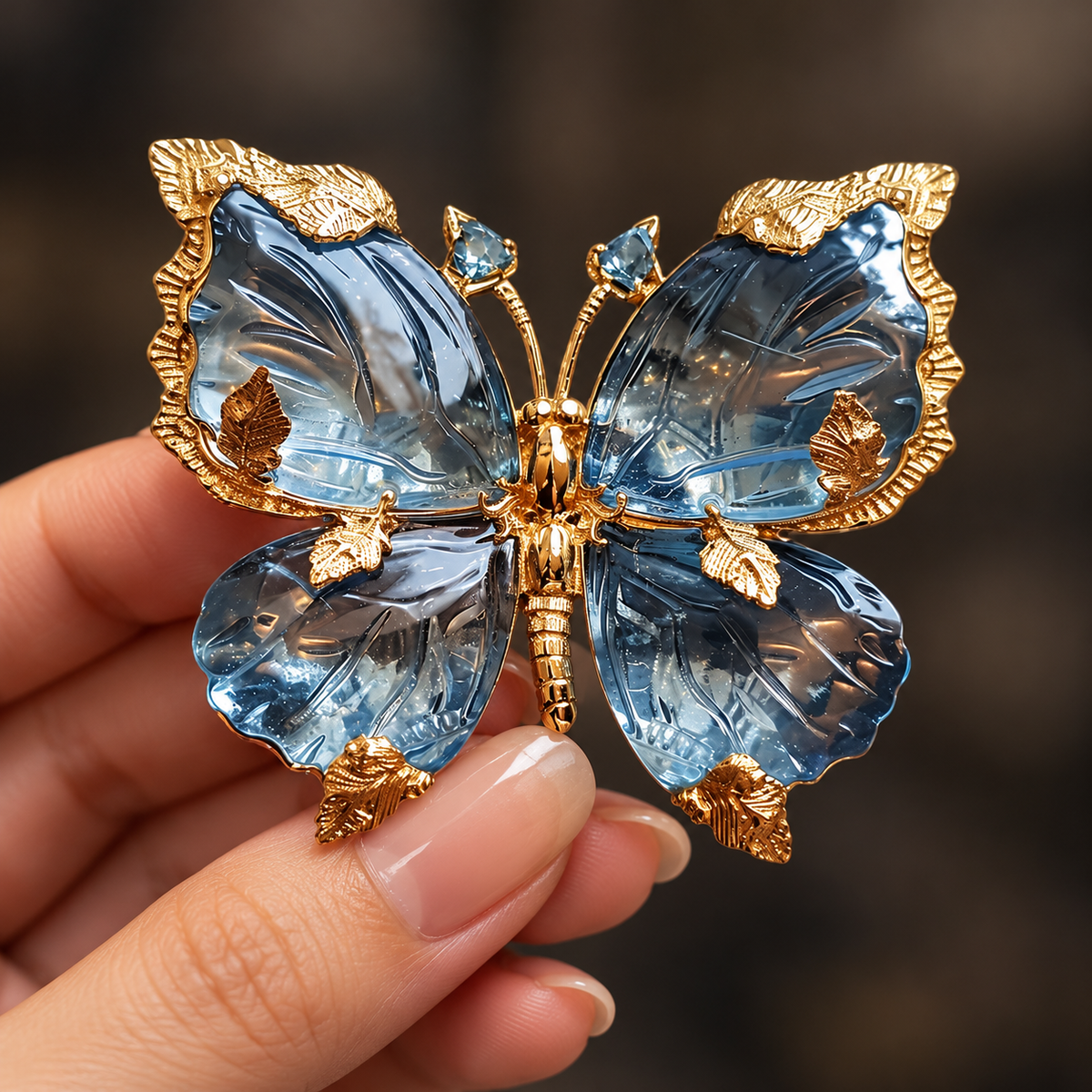 Blue butterfly brooch design held in a hand