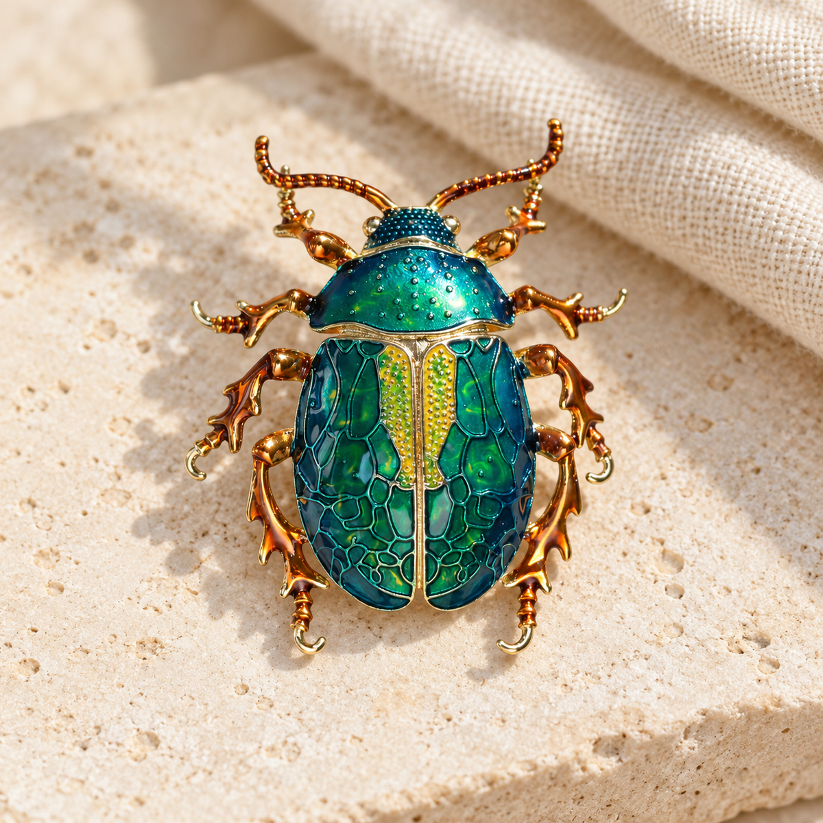 Dark Green enamel beetle brooch, styled tabletop display