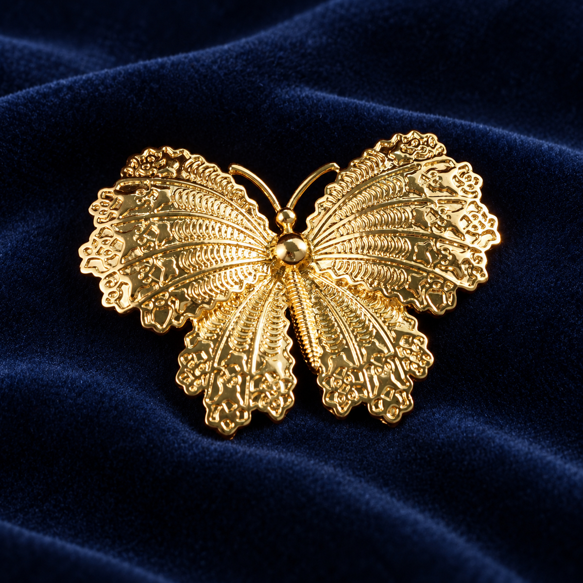 Gold tone butterfly brooch with openwork wings