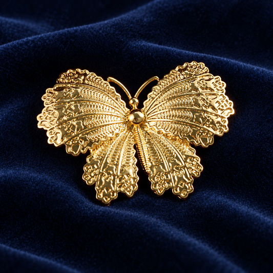 Gold tone butterfly brooch with openwork wings