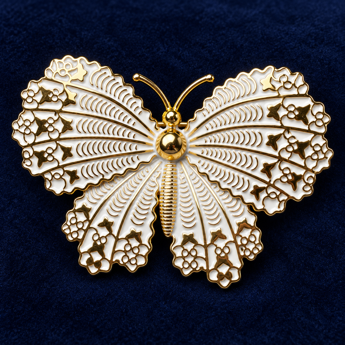 Gold Tone and White butterfly brooch with intricate wing details