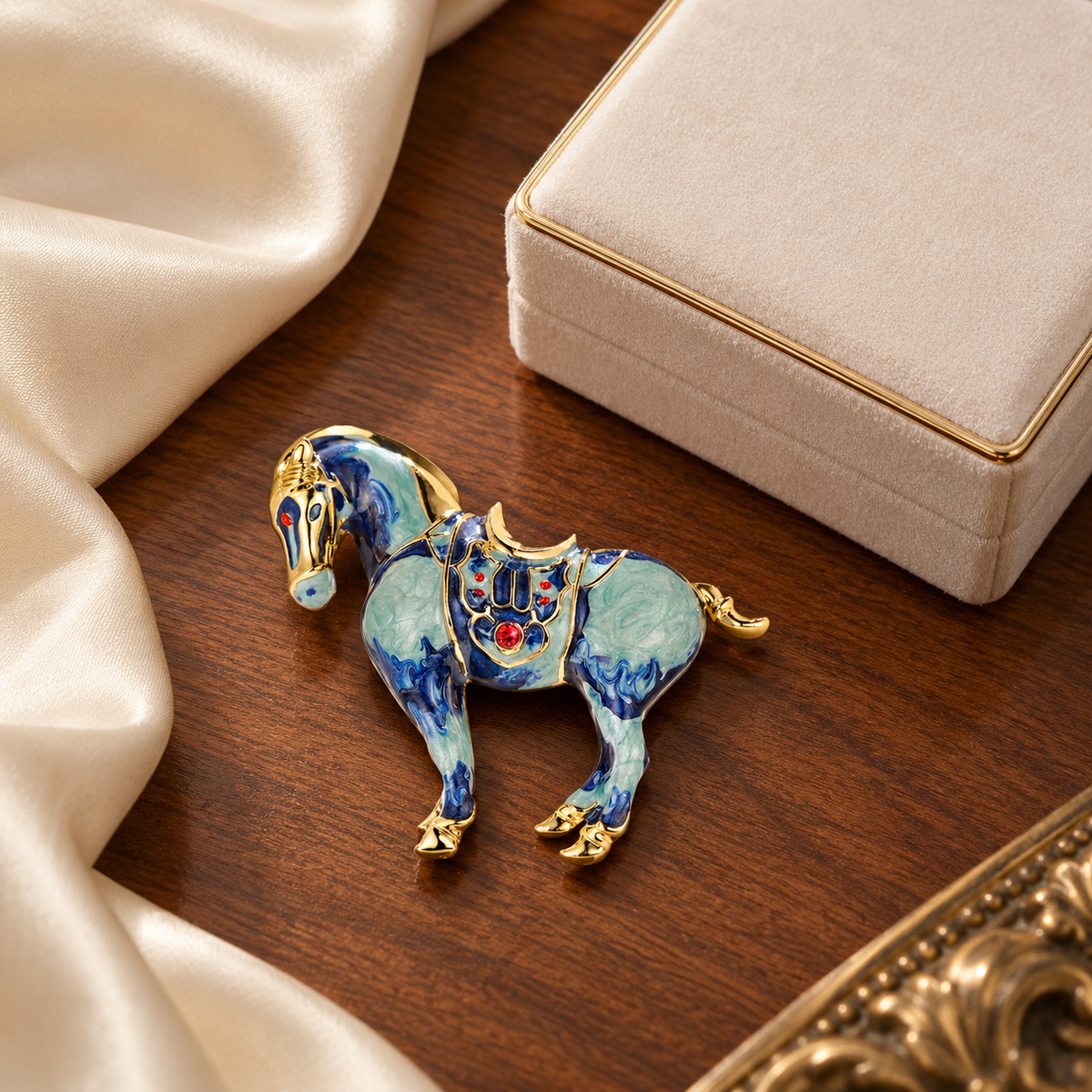 Blue horse brooch styled in a tabletop setting