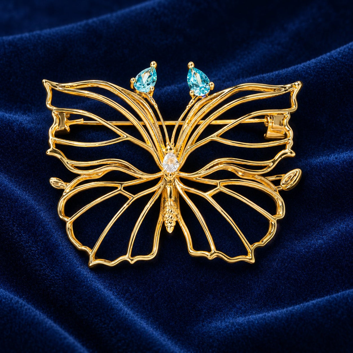 Sea Blue openwork butterfly brooch, front view with gold-tone frame and blue accents