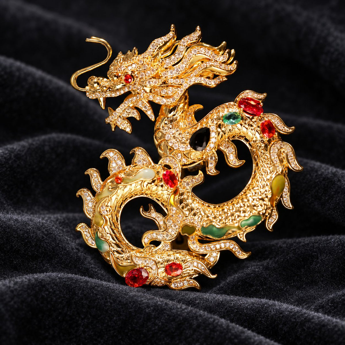 Dragon brooch, front view with curled gold-tone body and red, green, and dark accents