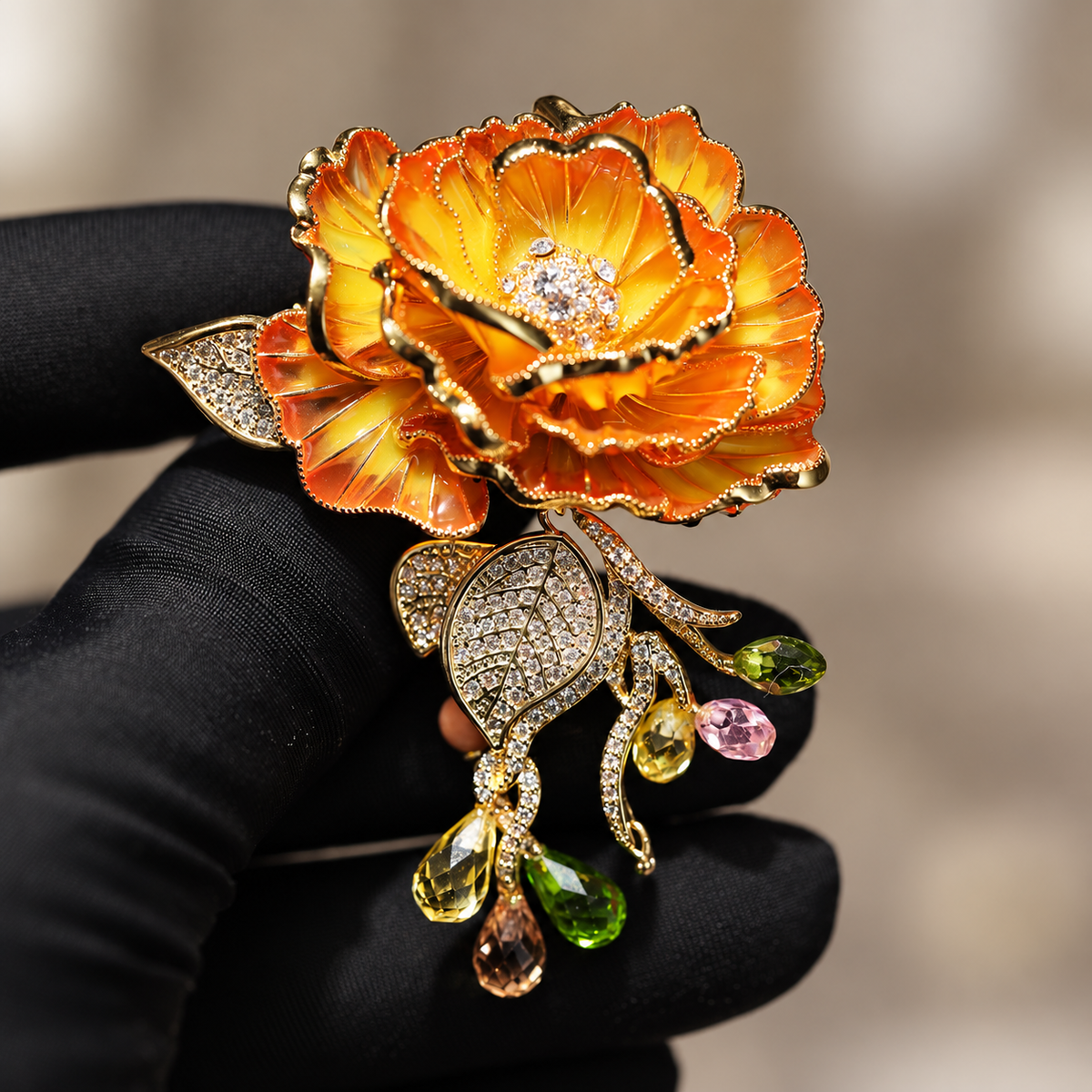 Orange Rose enamel rose brooch held in a hand