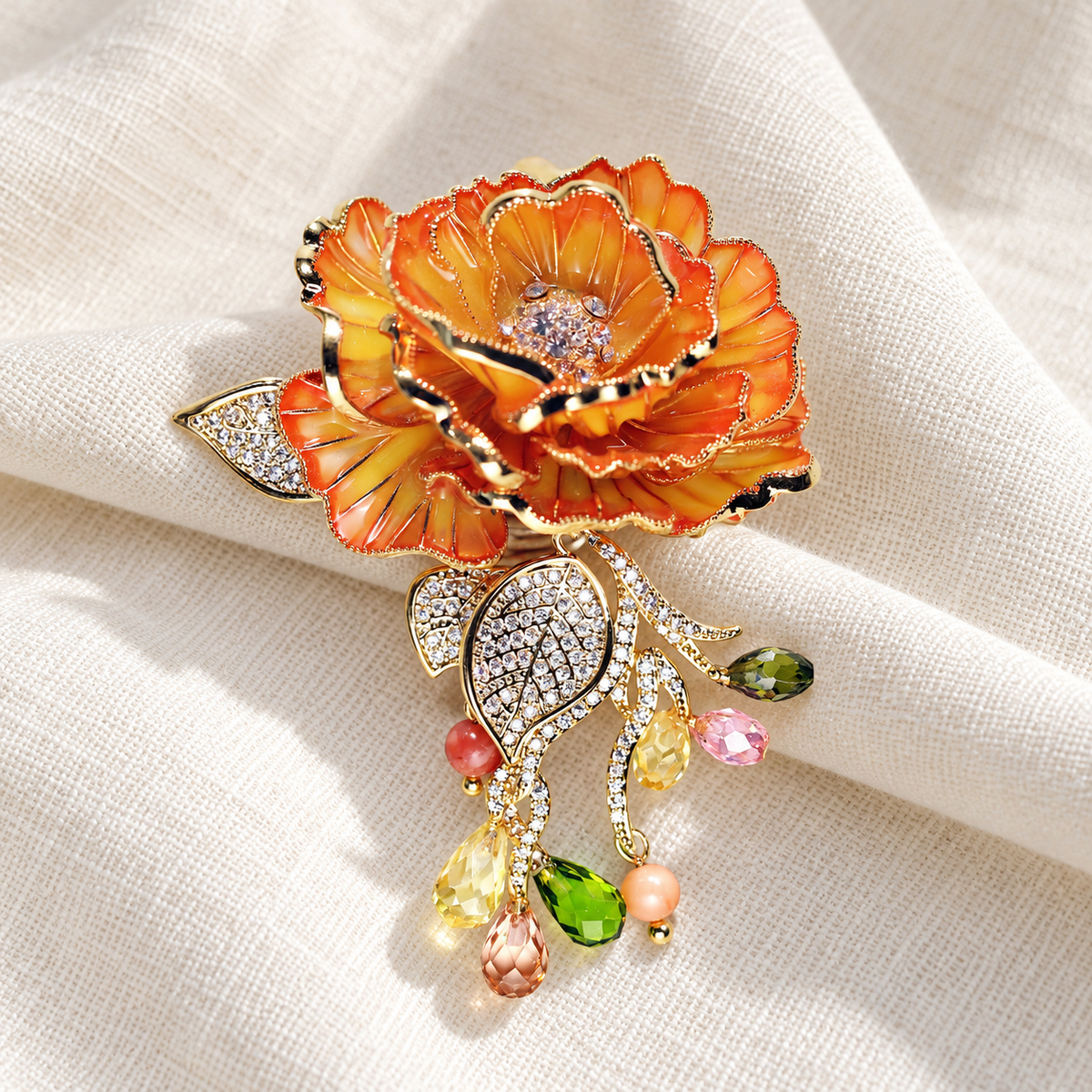 Orange Rose enamel rose brooch in a tabletop setting