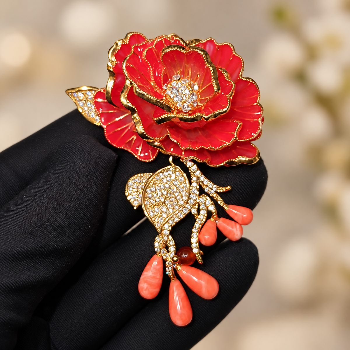 Red Rose enamel rose brooch held in a hand