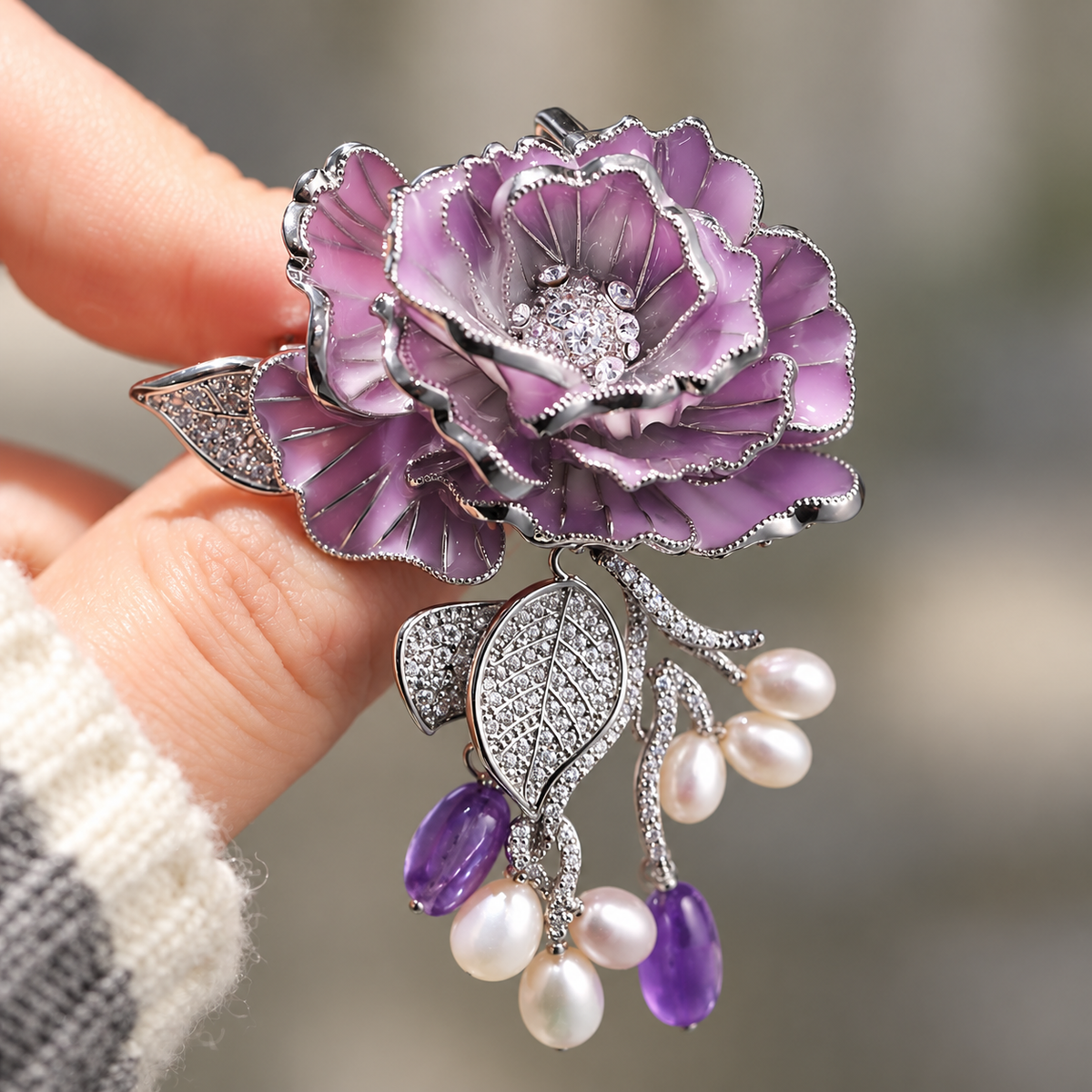 Purple Rose With Freshwater Pearls enamel rose brooch held in a hand