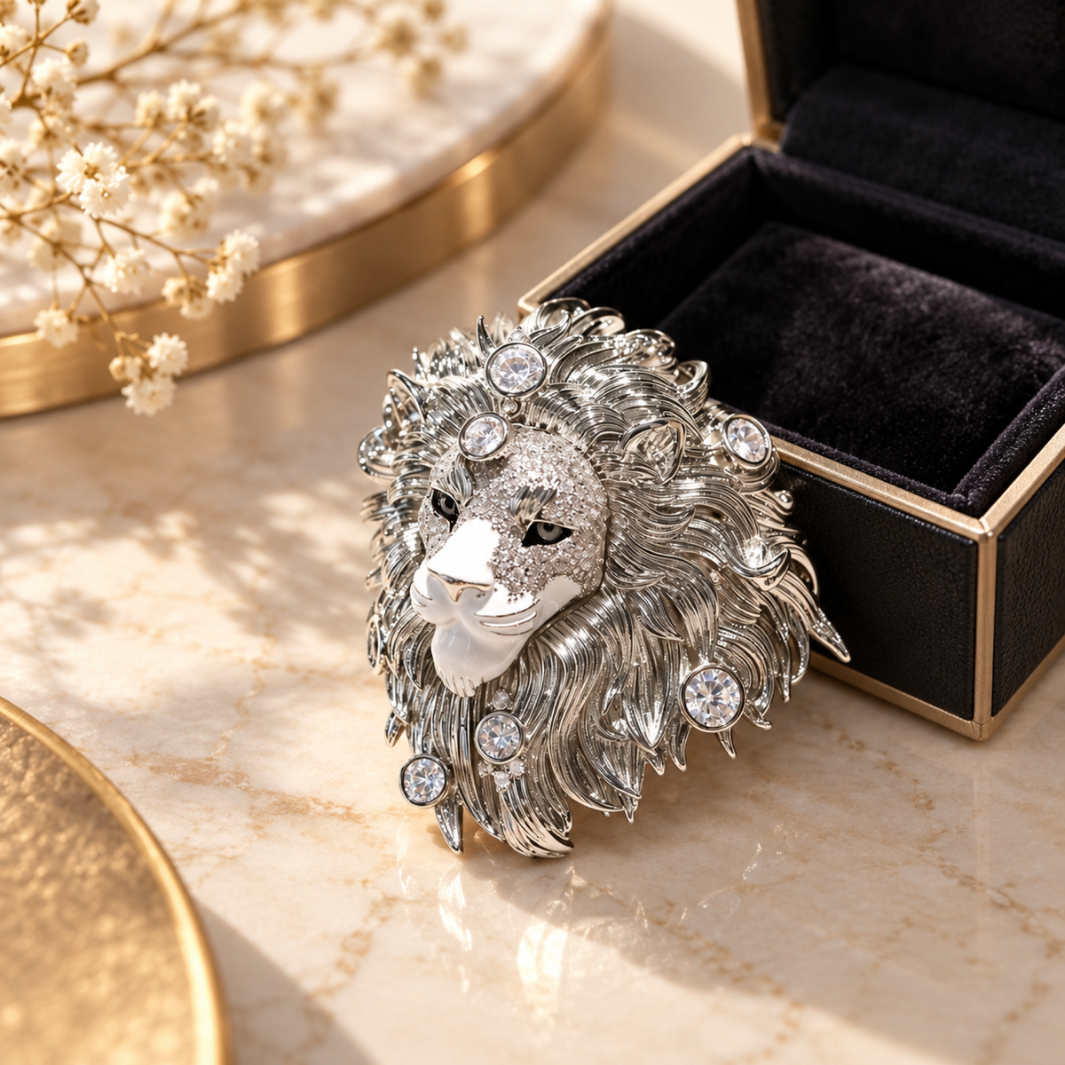 Silver tone lion head brooch in a styled tabletop display