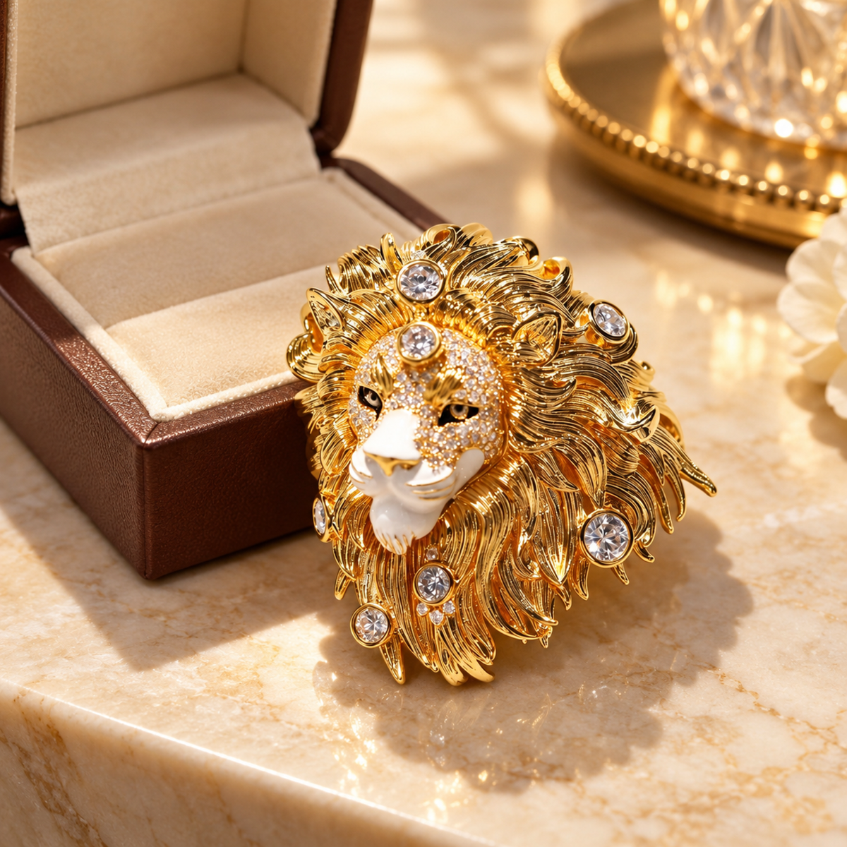 Gold tone lion head brooch in a styled tabletop display